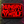 A rectangular black plaque or sign with a red border and bold red text reading “HUNGRY LIKE A WOLF,” photographed on a dark textured surface with colored lighting.